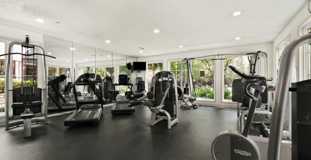 Professional personal training studio interior with strength machines, cardio equipment, and open training floor, Studio OS Professional