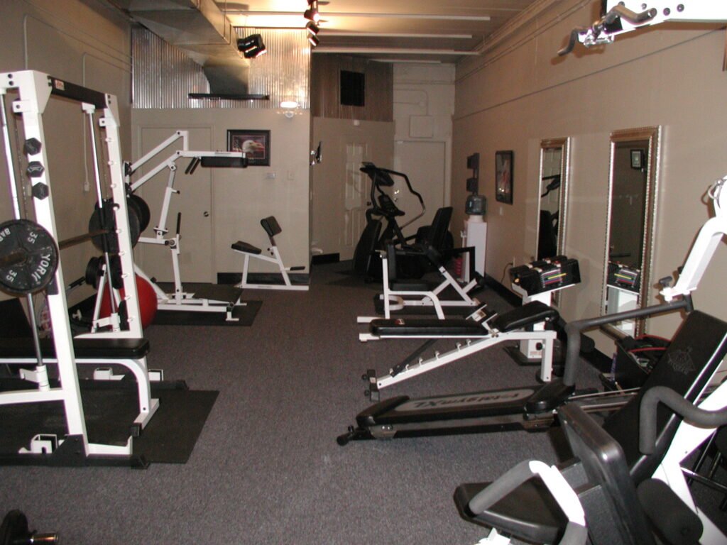 Interior of a compact 850-square-foot personal training studio with strength, cardio, and free-weight equipment